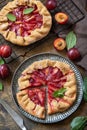 Healthy homemade wholegrain fruit pie, sweet crostata on a rustic table. Vegan vegetarian dessert, plums galette with almonds Royalty Free Stock Photo