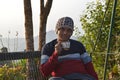 Healthy Indian man drinking tea in morning at the park . Traveling man enjoying tea in Darjeeling, India