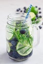 Healthy infused water with fresh blueberry, lime and rosemary, vertical Royalty Free Stock Photo