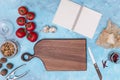 healthy ingredient kitchen utensil with open blank diary blue textured backdrop. High quality photo