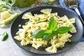 Healthy Italian cuisine. Pasta with green peas and pesto sauce in black bowl Royalty Free Stock Photo