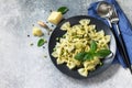 Healthy Italian cuisine. Pasta with green peas and pesto sauce in black bowl on grey stone background. Royalty Free Stock Photo