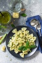 Healthy Italian cuisine. Pasta with green peas and pesto sauce in black bowl Royalty Free Stock Photo