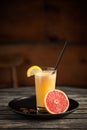 Healthy juice made of red orange, on wooden table