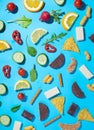 Healthy and junk food diet choices concept made from snacks in pattern on blue background Royalty Free Stock Photo