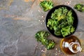 Healthy kale chips, above scene on slate with copy space