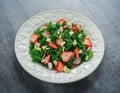 Healthy kale salad with strawberries and almond in a white plate