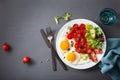 Healthy keto diet breakfast: egg, tomatoes, salad leaves and bacon