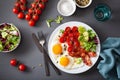 Healthy keto diet breakfast: egg, tomatoes, salad leaves and bacon