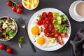 Healthy keto diet breakfast: egg, tomatoes, salad leaves and bacon