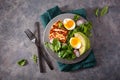 Healthy keto paleo diet breakfast: boiled egg, avocado, halloumi cheese, salad leaves