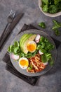 Healthy keto paleo diet breakfast: boiled egg, avocado, halloumi cheese, salad leaves