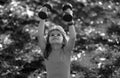 Healthy kid boy with dumbbell exercise outdoor. Little child practice dumbbells exercises in park. Funny excited child