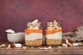 Healthy layered breakfast or dessert with puffed quinoa grains, yogurt and coconut flakes and pieces in glass