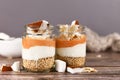 Healthy layered breakfast or dessert with puffed quinoa grains, yogurt and coconut flakes and pieces in glasses