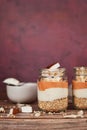 Healthy layered breakfast or dessert with puffed quinoa grains, yogurt and coconut flakes and pieces