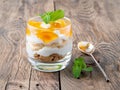 Healthy layered dessert with yogurt, banana, mango jam, cookie o