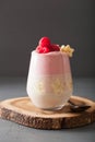 Healthy layered raspberry banana smoothie in glass