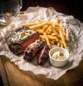 Healthy lean grilled medium-rare steak with french fries, beer