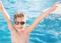 Healthy lifestyle. Active, happy nine years old child boy in sport goggles having fun in the swimming pool. Caucasian kid.