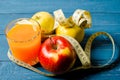 Healthy lifestyle. Apple and orange juice on a wooden background Royalty Free Stock Photo