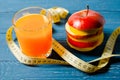 Healthy lifestyle. Apple and orange juice on a wooden background Royalty Free Stock Photo