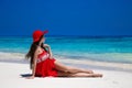 Healthy lifestyle. Beautiful carefree woman in hat enjoying exotic sea, brunette lying on tropical beach at summer holiday. Royalty Free Stock Photo