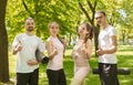 Four friends satisfied of successful training outdoors showing thumbs up