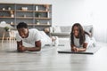 Young black couple planking together in living room Royalty Free Stock Photo