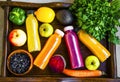 Healthy lifestyle concept with juice bottles, vegetables and fruits on wooden tray, top view, healthy living fitness Royalty Free Stock Photo