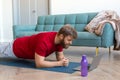 Middle-aged bearded man doing the plank exercise - he follow the online tutorial from internet. Royalty Free Stock Photo