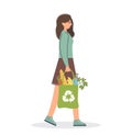 Young woman carries an eco bag with groceries. Green lifestyle