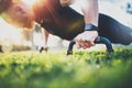 Healthy lifestyle concept.Training outdoors.Handsome sport man doing pushups in the park on the sunny morning. Blurred