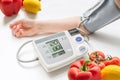 Healthy lifestyle concept. Woman is measuring blood pressure with monitor.