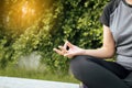 Healthy and lifestyle concept,Woman sitting practicing doing yoga exercise,workout after waking up at public park Royalty Free Stock Photo