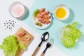 Healthy lifestyle - cooking of fresh salad of prawn, green salad, olive, black pepper, pink salt in sunlight with shadow, flat lay