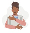 Healthy lifestyle, diet, weight loss concept. Young African-American woman holds a scale in her hands, and feels confident, having