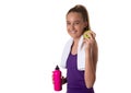 Healthy lifestyle - fitness girl eating apple smiling happy looking at camera and holding a water bottle. Pretty Caucasian woman Royalty Free Stock Photo