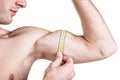 Healthy lifestyle and fitness. Handsome guy sportive, measuring muscles, isolated on white background. Horizontal frame