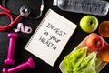 Healthy lifestyle, food and sport concept. Top view of Stethoscope measuring tape pink dumbbell, sport water bottles, fruit and Royalty Free Stock Photo