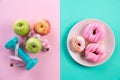 Healthy lifestyle, food and sport concept. Top view of healthy versus unhealthy. donut versus measuring tape with athlete`s Royalty Free Stock Photo