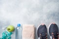 Healthy lifestyle, food and water, athlete`s equipment on grey background. Flat lay. Top view with copy space Royalty Free Stock Photo