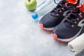 Healthy lifestyle, food and water, athlete`s equipment on grey background. Flat lay. Top view with copy space Royalty Free Stock Photo