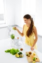 Healthy Lifestyle. Happy Vegetarian Woman Making Detox Smoothie. Royalty Free Stock Photo