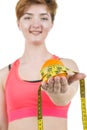 Healthy lifestyle, healthy eating. A young girl holds an orange and a measuring tape, on a white background. Horizontal frame