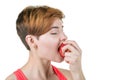 Healthy lifestyle, healthy eating. Young girl passionately and sexually eats a apple, on a white isolated background. Horizontal f Royalty Free Stock Photo