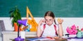 Healthy lifestyle. Kid student in school. Schoolgirl sit desk chalkboard background. Girl small child eating apple snack Royalty Free Stock Photo