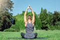 Healthy Lifestyle. Man practicing yoga outdoors sitting back meditating hands up peaceful Royalty Free Stock Photo