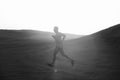 Healthy lifestyle. Man runner running in dune at sunset Royalty Free Stock Photo