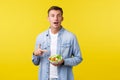 Healthy lifestyle, people and food concept. Excited happy man pointing finger at bowl with salad, delighted, amazed with